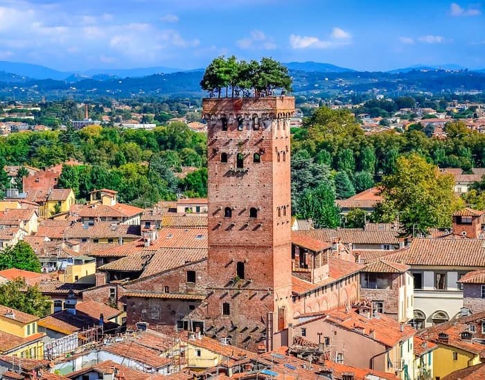 Guinigi Tower in Lucca, Italy, with oak trees on the top.