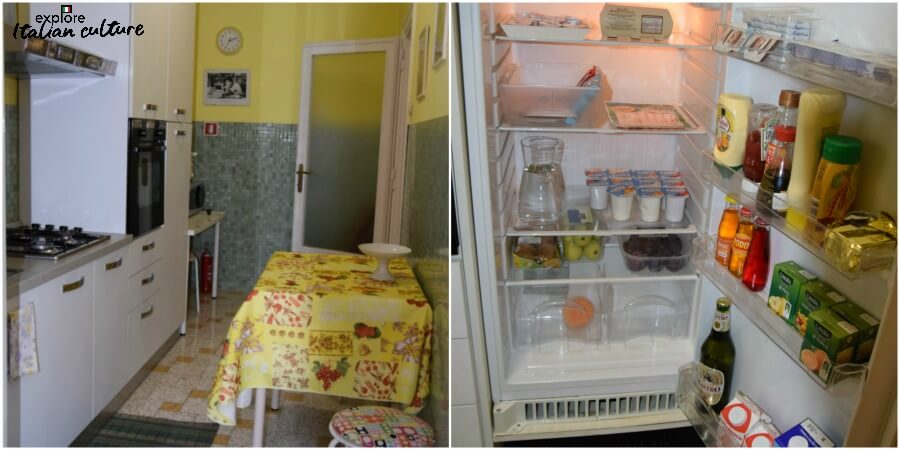 The apartment's kitchen, showing the narrow layout and the fridge crammed with food and drink.