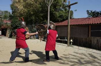 Two people staging a mock fight at Gladiator school