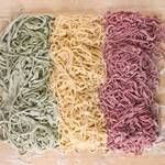 Three piles of colored pasta