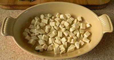 A bowl of mozarella cheese cut into small cubes