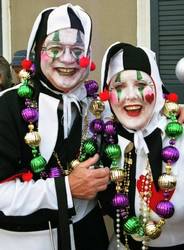Mardi Gras history A man and a woman dressed in black and white Mardi Gras costumes