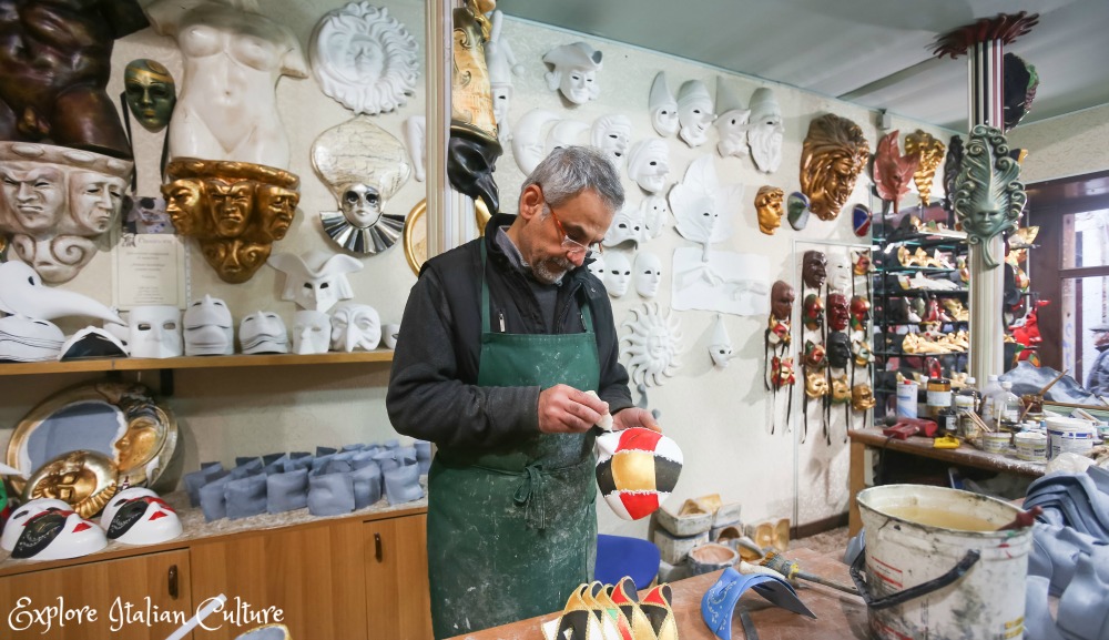 Mask-making in Venice, Italy. A man in a green apron Mask-making in Venice.