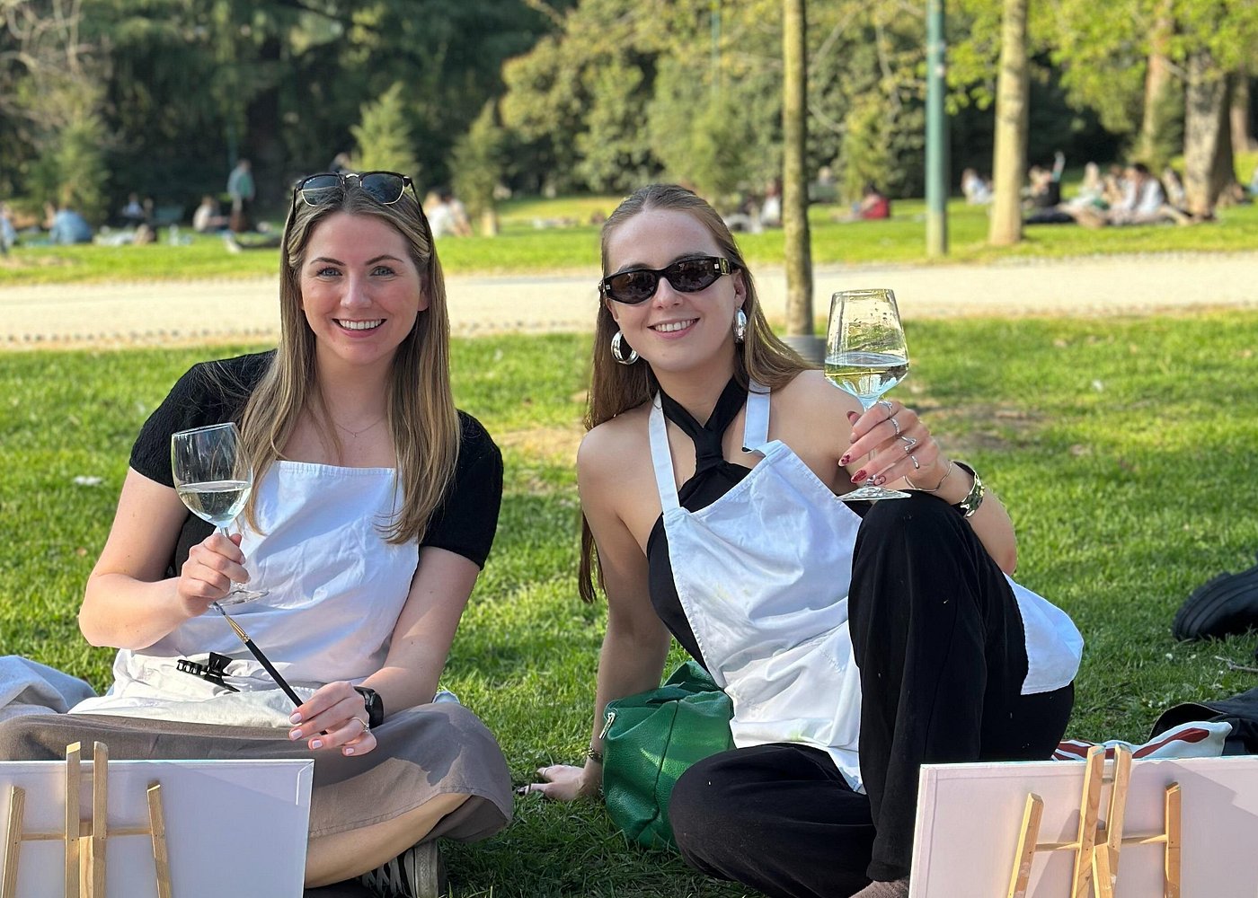 girls drinking wine in a park