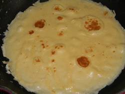 A pancake in a frying pan