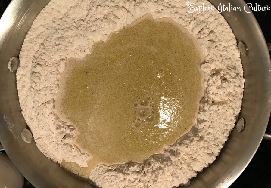 Make a well in the centre of the flour and add the liquid.