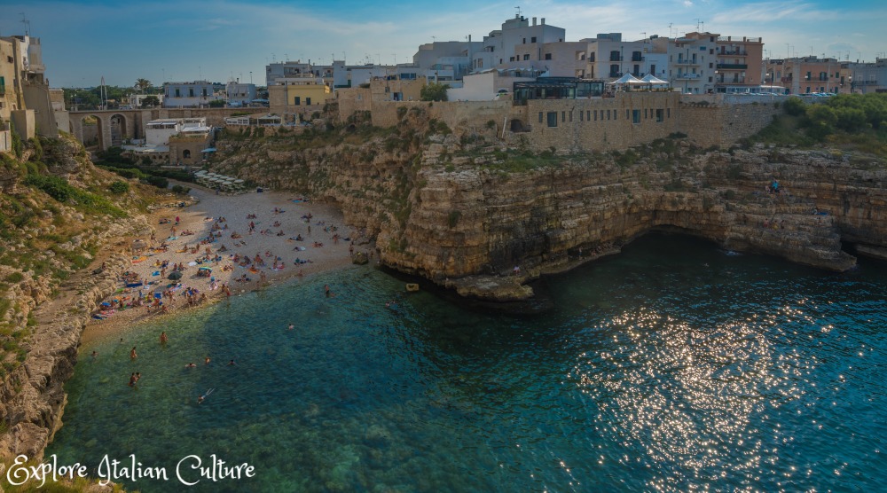 The beach at Polignano a Mare, Puglia, Italy - formed by a break in two rock faces and surrounded by the town of Polignano itself.