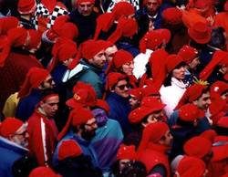 Men wearing red hats at carnevale