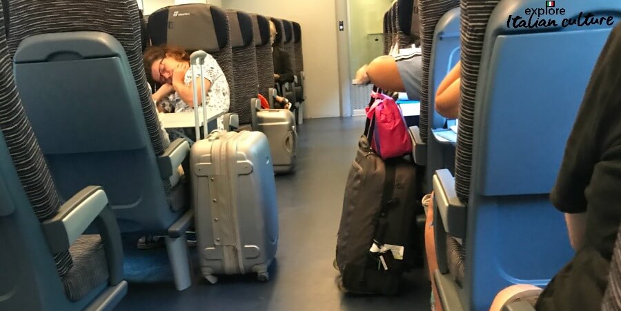Luggage kept in the aisle of a local train in Italy.