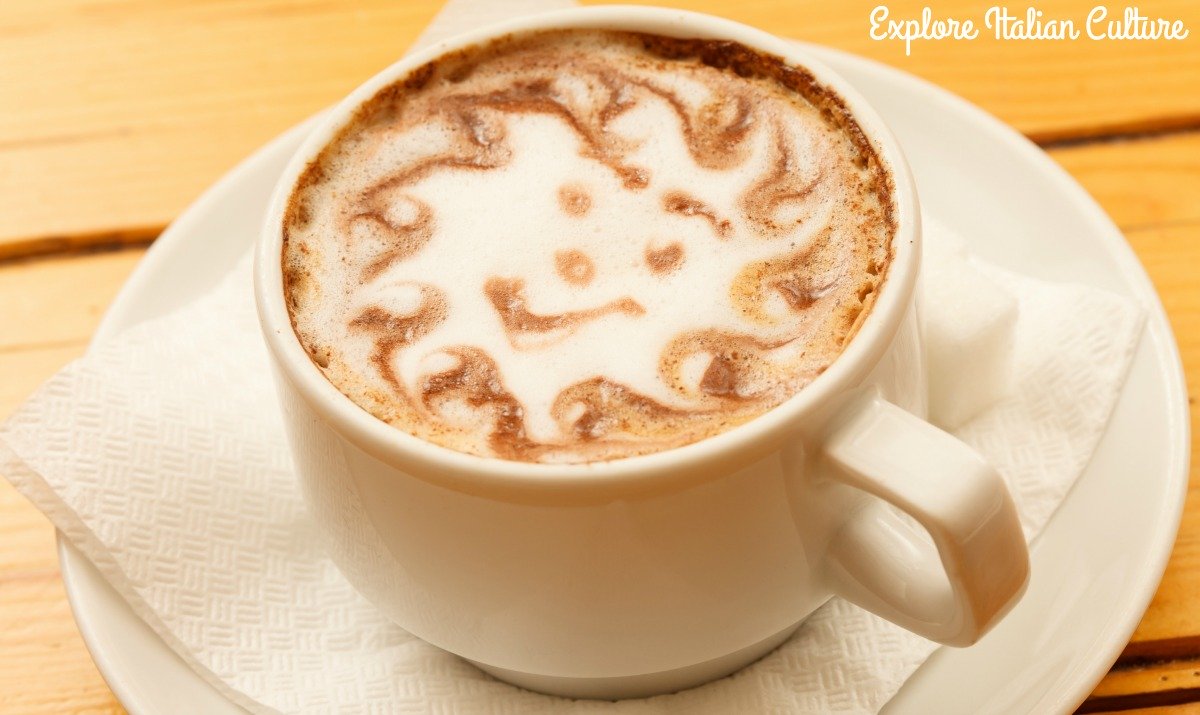 A cup of cappuccino in a white cup and saucer