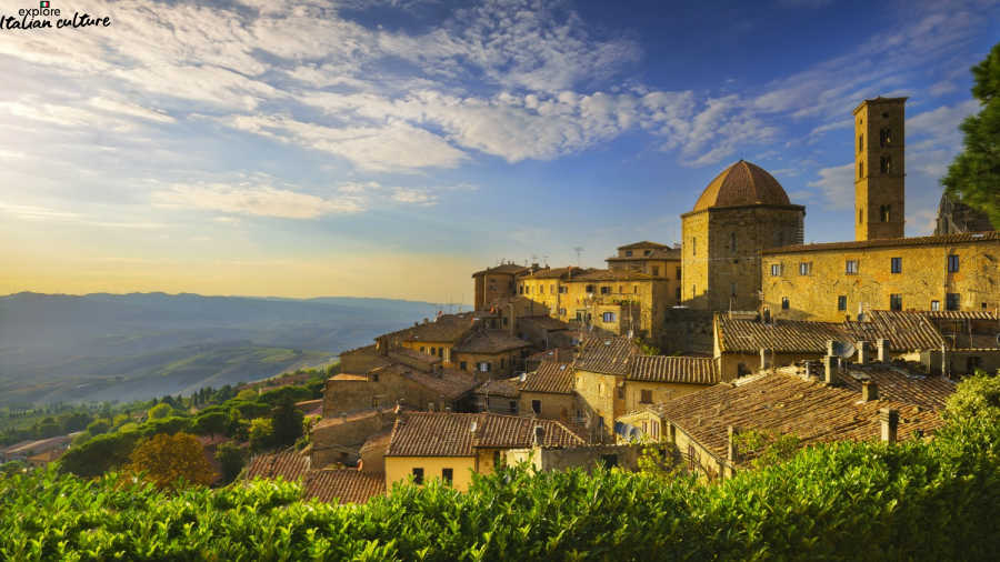 Italian hilltop village under a blue sky.